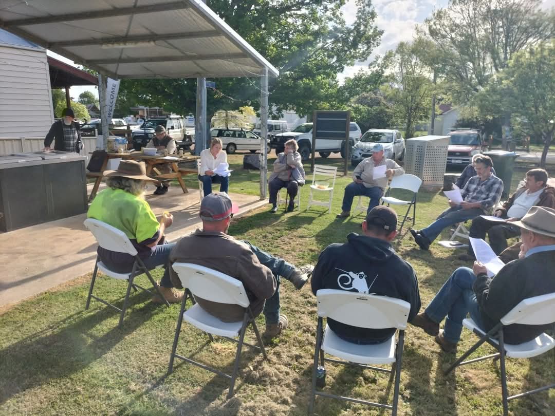 the mens shed committee having an outdoor meeting